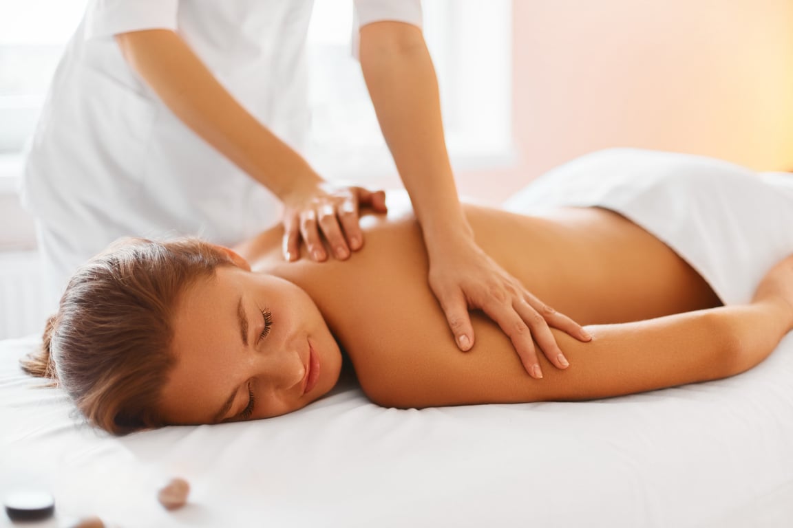 Spa Treatment. Woman enjoying Massage in Spa centre.